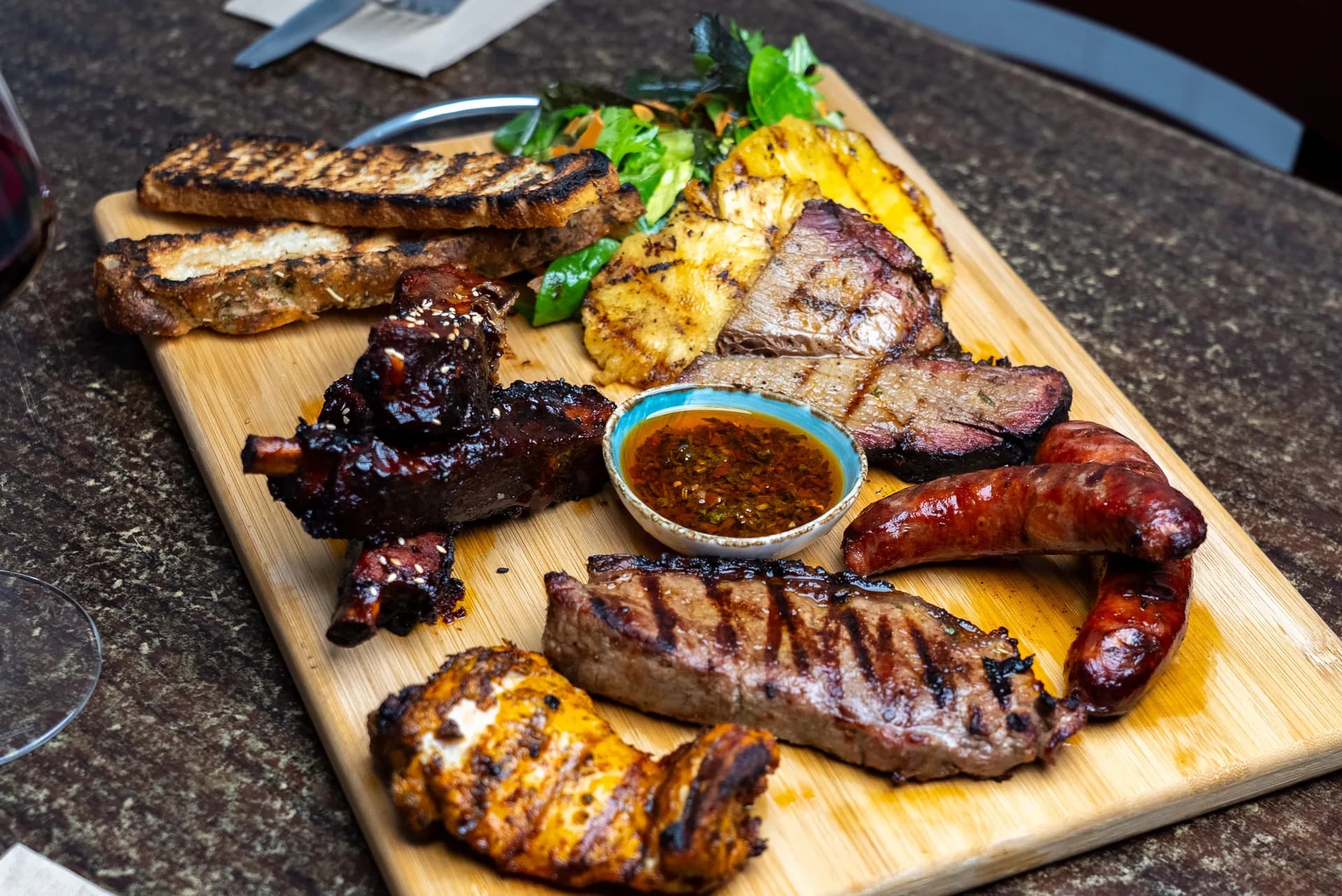 Platter From The Fire with smoked brisket, pork ribs, grilled chicken, and chorizo at Saltwood, Ferrymead.