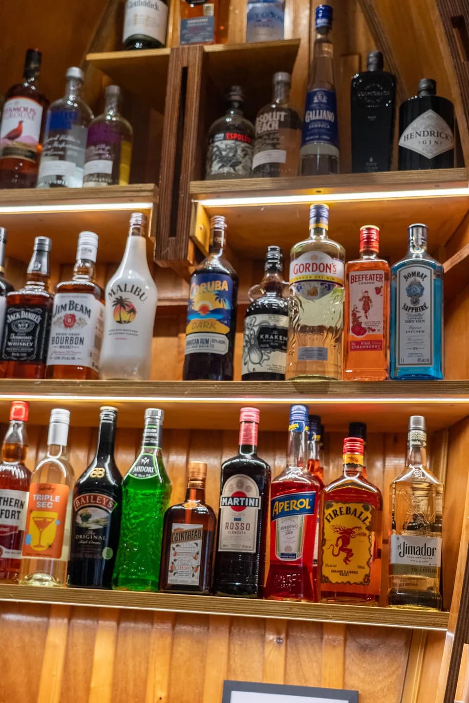 Back-bar spirits selection with warm LED lighting at Saltwood, Ferrymead.