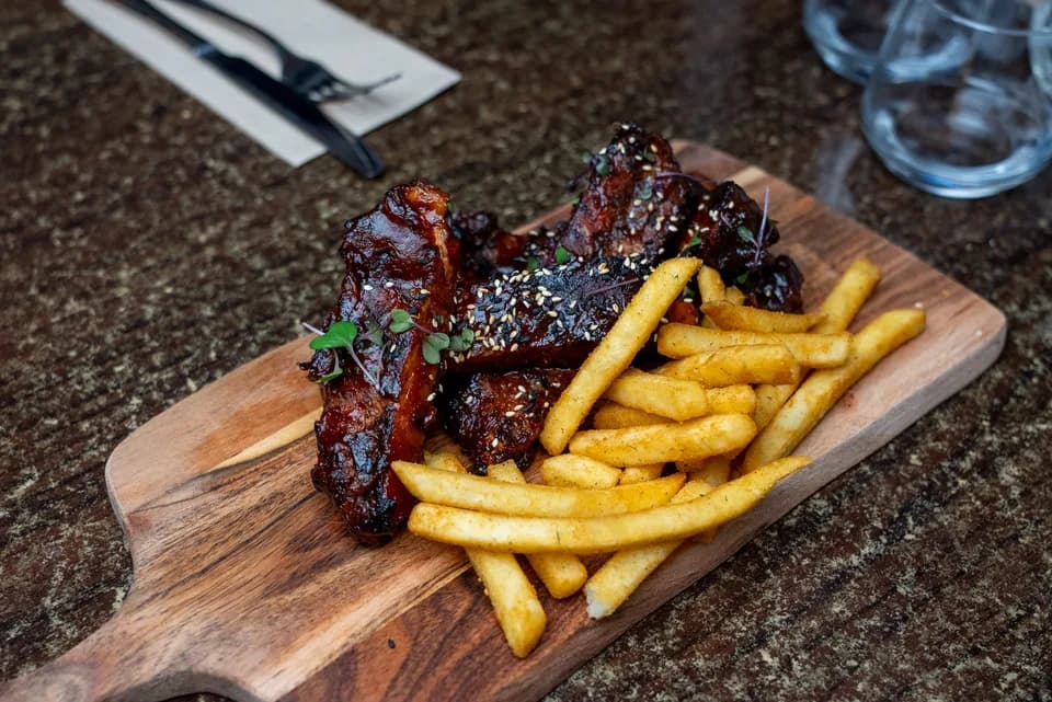 BBQ pork ribs glazed with sesame seeds, served with seasoned fries at Saltwood, Ferrymead.