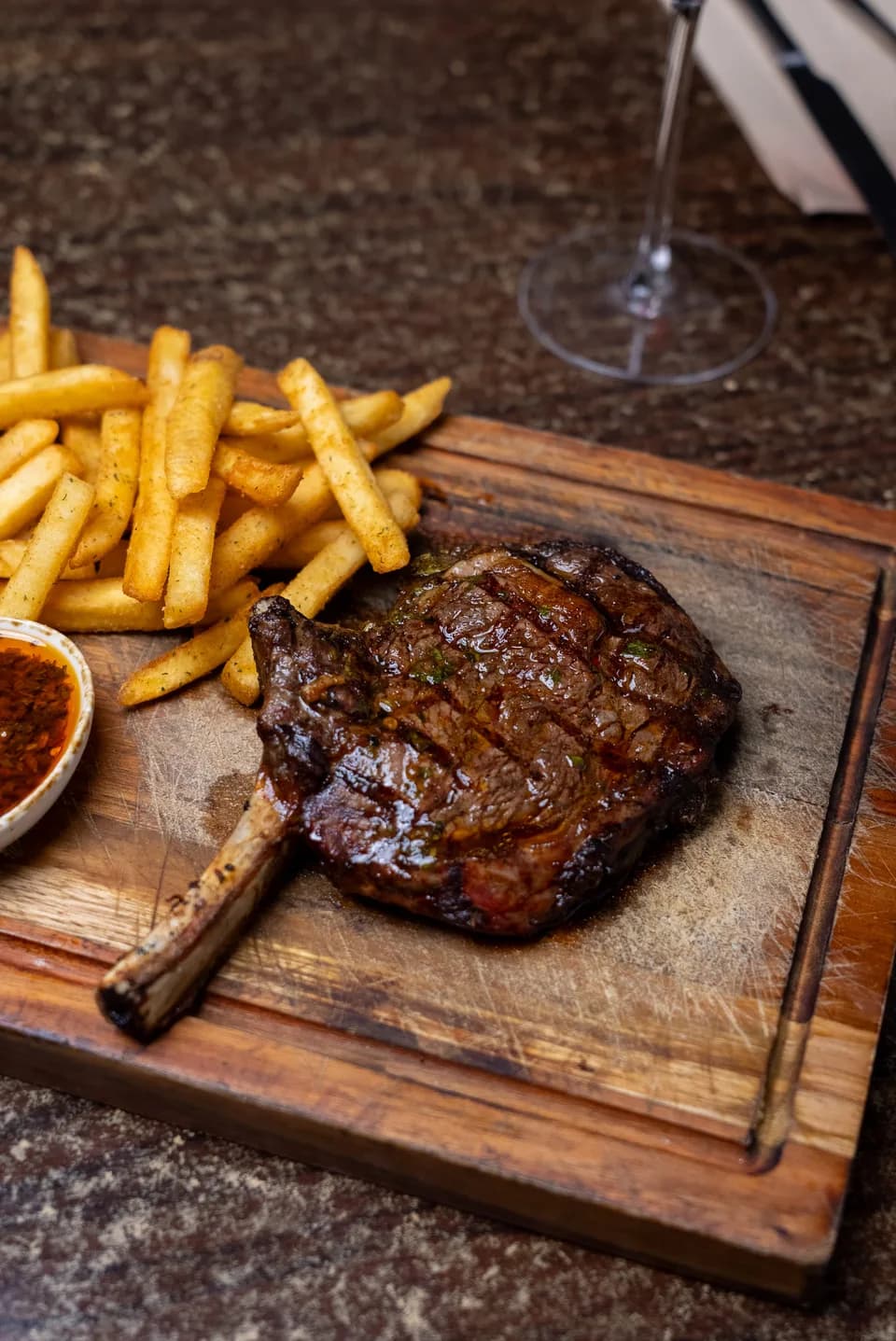 Bone-in ribeye steak with fries and chimichurri sauce at Saltwood, Ferrymead.