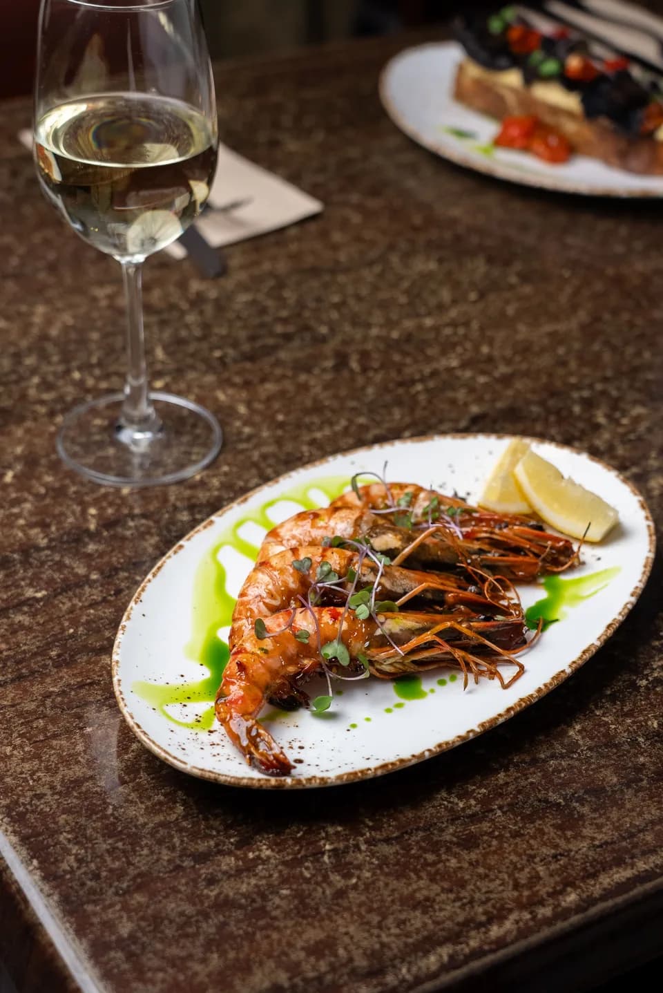 Grilled chilli butter tiger prawns on a wooden board at Saltwood, Ferrymead.